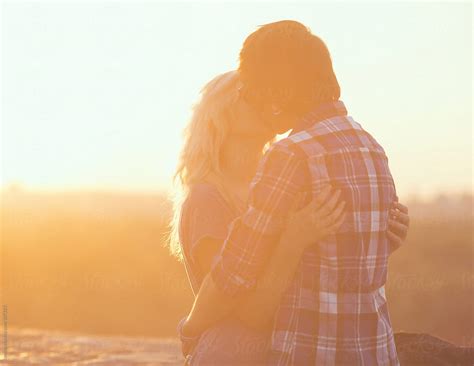 teenage couple kissing in the sunset by stocksy contributor lumina stocksy