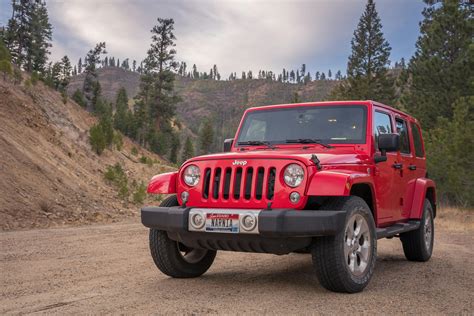 Red Jeep Parked In The Middle Of A Dirt Road · Free Stock Photo