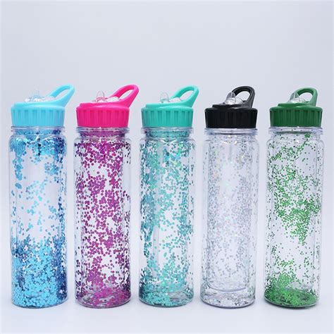 Four Different Colored Water Bottles Lined Up Next To Each Other