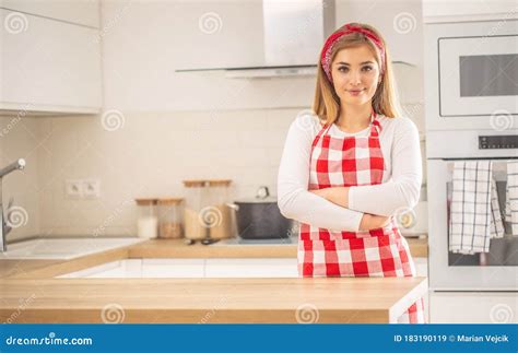 Young Woman Stand Confidently In The Kitchen Wearing Apron Stock Image Image Of Caucasian