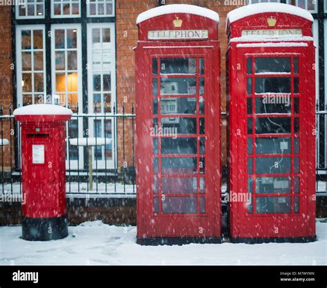 Typical British Red Pillar Post Box And Telephone Box Covered In Snow