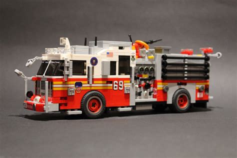 A Toy Fire Truck Is Shown On A Gray Surface