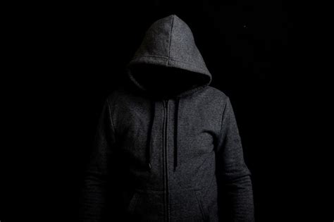 Premium Photo Man Without A Face In A Hood On A Dark Background