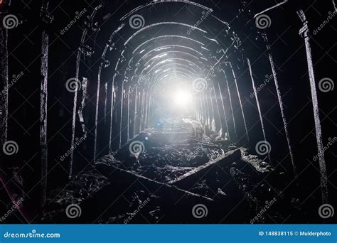 Dark Abandoned Coal Mine with Rusty Lining in Backlight Stock Image