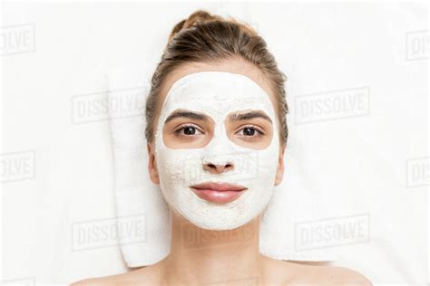 Spa Therapy For Attractive Woman Receiving Facial Mask Stock Photo