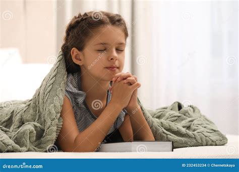 Cute Little Girl Praying Over Bible In Bedroom Stock Photo Image Of