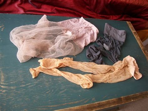 Several Pieces Of Cloth Sitting On Top Of A Wooden Table Next To A Red
