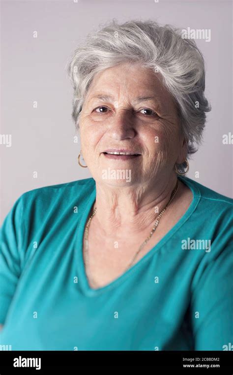 Senior Woman Smiling In Studio Portrait Stock Photo Alamy