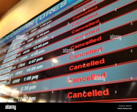 Flight Departures Board Showing All Flights Canceled During A Snow