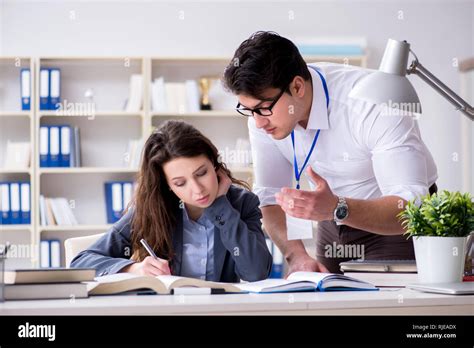 Teacher Explaining To Student At Lecture Stock Photo Alamy