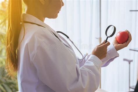 Doctor Asian Women Using Magnifying Glass With Heart Red Color In