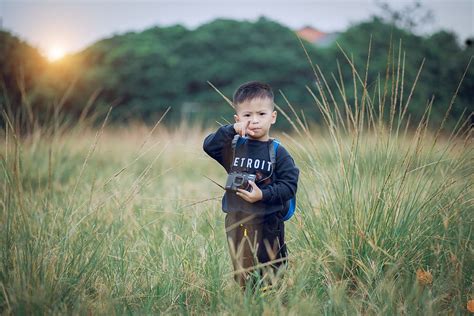 Hd Wallpaper Boy Standing On Green Field Holding Black Camera Child