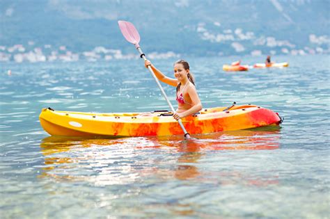 Girl Enjoying Paddling In Kayak On The Sea Water Stock Photo Download