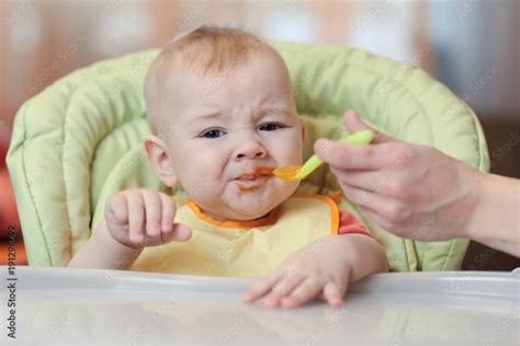 Cute Baby Boy Refusing To Eat Food From Spoon With Face Dirty Of
