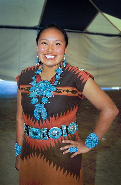 navajo woman dressed in a woven wool dress adorned with traditional turquoise necklace braclets