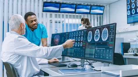 Medical Scientist And Surgeon Discussing Ct Mri Brain Scan Images On