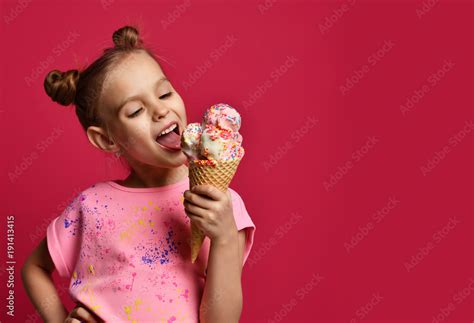 Pretty Baby Girl Kid Eating Licking Big Ice Cream In Waffles Cone With