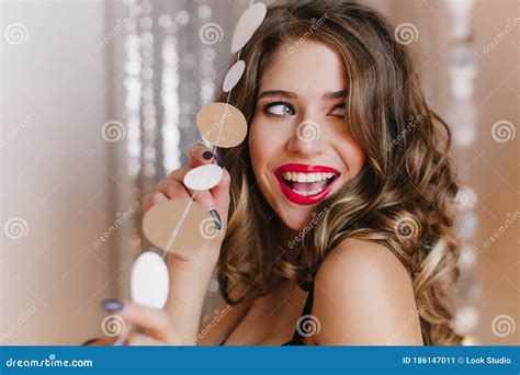 Close Up Portrait Of Female Model At Party Girl With Beautiful Make Up Laughs Touching Thread
