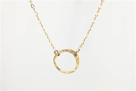 Thus, you can buy white gold minimalist jewellery from fancime even in customized options that perfectly blend with your style. Simple Zen Circle - Rustic Minimalist Circle Necklace - Hammered Gold - dirtypretty artwear