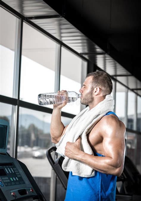 Young Man Drinking Water In Gym Stock Photo Image Of Exhausted