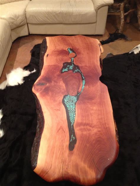 It was inlayed with epoxy and blue pearl inlay. Live Edge Coffee table. Made with Alligator Juniper ...