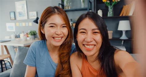teenager asian women feeling happy smiling selfie and looking to camera while relax in living