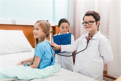Kids With Stethoscopes And Clipboard Playing Doctors With Little
