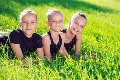 Three Girls Lying In The Grass And Having Fun Stock Image Image Of