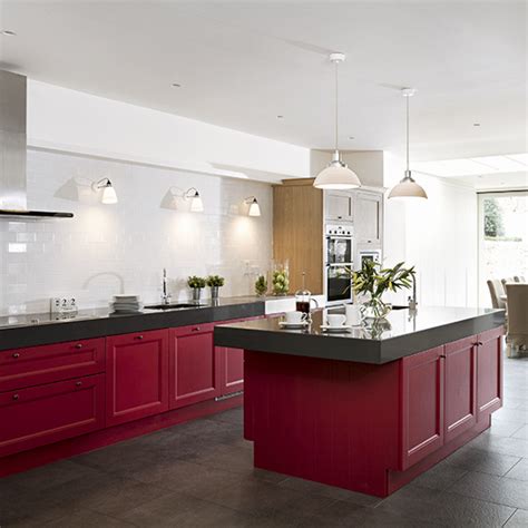 Red really pops when paired with white cabinets and black surfaces. Red kitchen colour ideas - home trends | Ideal Home