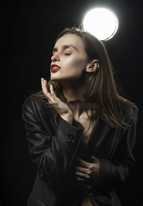 Beautiful Braless Girl With Red Lips Wearing An Unbuttoned Black