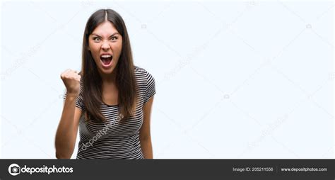 Young Beautiful Hispanic Woman Angry Mad Raising Fist Frustrated