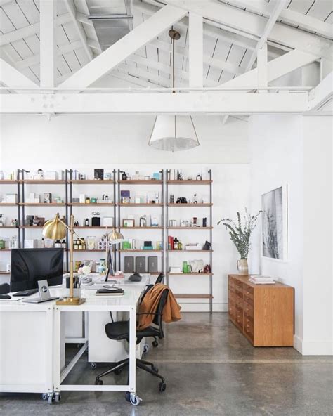 An Office With White Walls And Open Shelving
