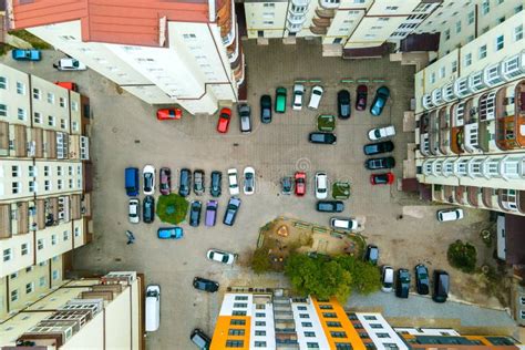 Aerial View Of Parked Cars On Parking Lot Between High Apartment