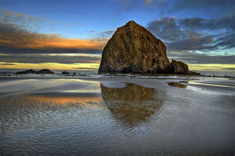 Haystack Rock Reflection In Cannon Beach Oregon Coast At Sunrise