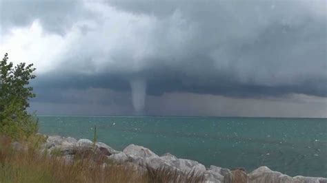 A tornado (= violently spinning column of air) filled with water that forms over the sea 2. Waterspouts On Lake Michigan - YouTube