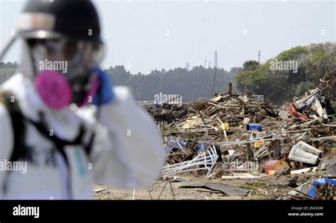 Namie Japan A Rescue Worker Clad In Protective Gear Searches For People Missing Since The
