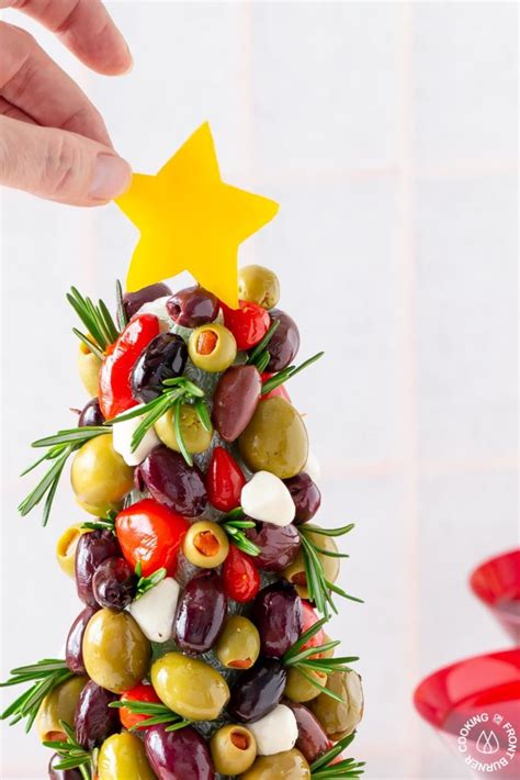 It uplifts the spirits of people during the winter and carries the refreshing scents of pine cones and spruce. Olive Christmas Tree Appetizer | Cooking on the Front Burner
