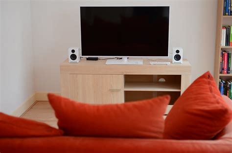 Floor to ceiling curved windows run the length of the room creating a view to die for. Couch and Panasonic TX-L42E6EW LCD TV | It's flanked by ...