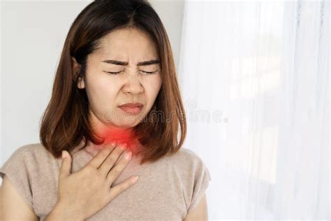 Unwell Asian Woman Suffering From Sore Throat Heartburn Hand Holding