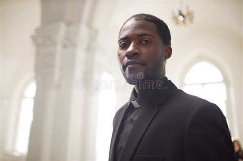 Young Black Man As Religious Priest In Church Setting Stock Photo