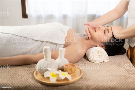 Beautiful Woman In Spa Environment Asian Woman In Bathrobe On Sofa As