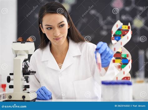 Unlocking The Mysteries Of Genetics A Female Scientist Observing A