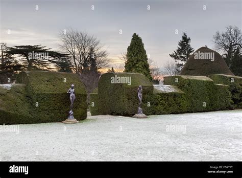 Yew Hedges And Nymph Statues In The Garden In Winter At Chirk Castle
