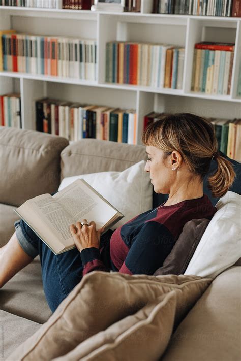 Woman Reading On The Couch By Stocksy Contributor Giada Canu Stocksy
