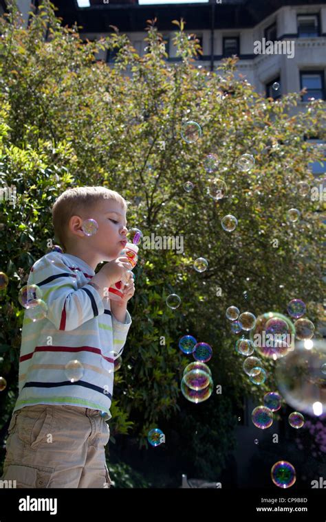 Young Boy Blowing Bubbles Stock Photo Alamy