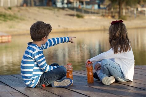 Boy And Girl Sitting By The River Stock Photo Image Of Resting