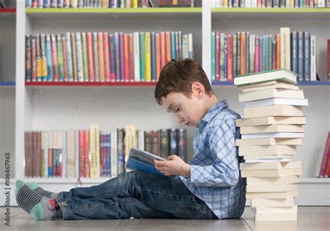 Cute Boy Reading Book In Library Stock Photo Adobe Stock