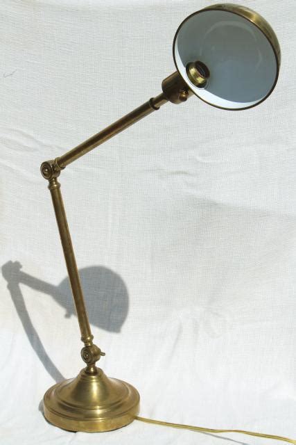 Includes a heavy duty tight grip steel spring clamp and an adjustable ball joint for multiple positioning of the light where it is needed. adjustable brass drafting work light, helmet shade desk lamp Jielde industrial style