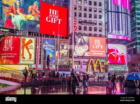 Crowded Times Square In Midtown Manhattan At Night Bright Led Screens Ads And Billboards