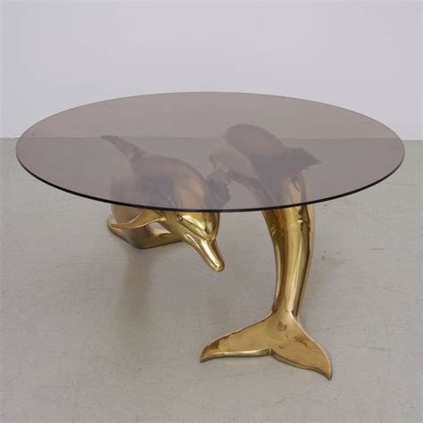 Beautiful display of dolphin breaking the surface of the water. Massive Brass Coffee Table in Form of Two Dolphins at 1stdibs